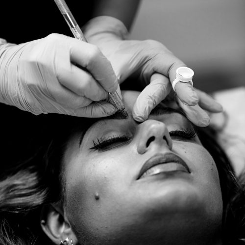 microblading close up, eyebrow adding pigment into skin.